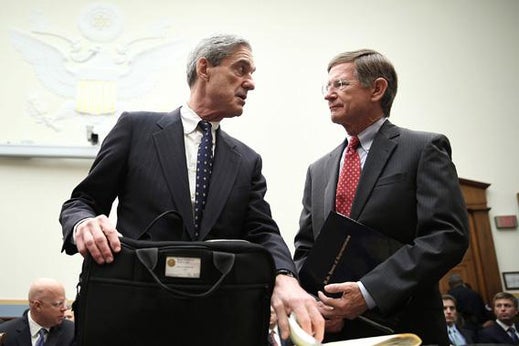 Federal Bureau of Investigation Director Robert Mueller (L) talks to Rep. Lamar Smith.